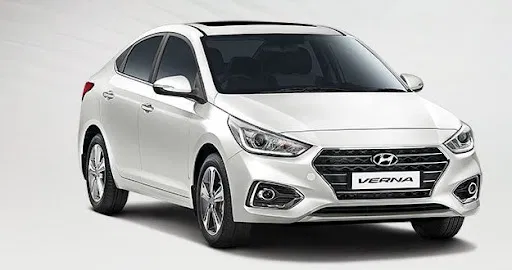 Spotless commercial white Hyundai tourist cab parked on Varanasi street